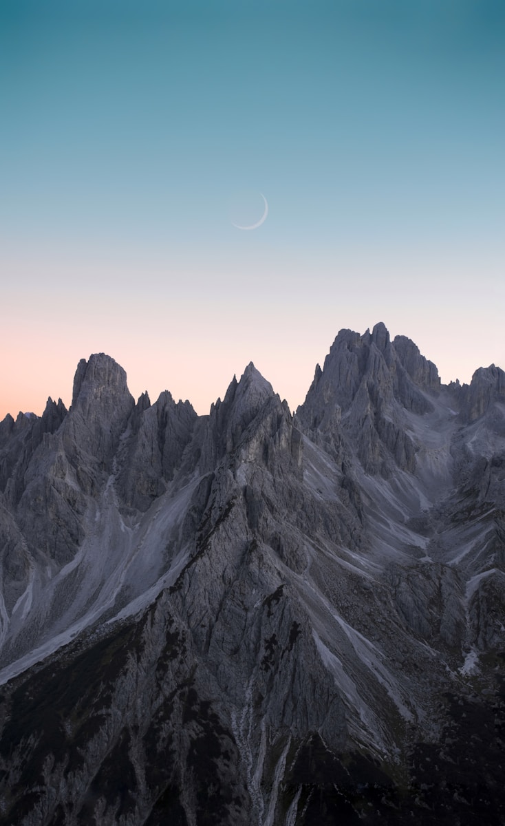 black and white mountains under blue sky